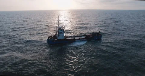 Sand ship hovering fly over in the ocean at sunset aerial 4k Video stock 153519709
