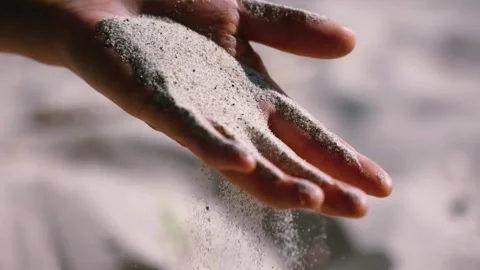 Sand is slipping from hand Stock Footage 247355505