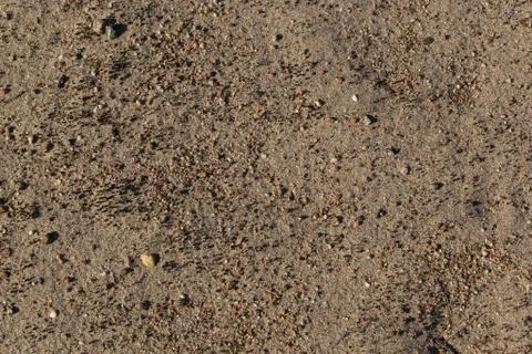 Sand with small stones. Stock Photos