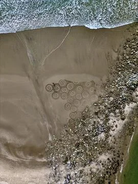 Sand spirals, beach artwork Stock Photos