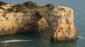 Sand stone cliff hole arch at Algarve coastline Portugal 4k or 4k+ Resolution