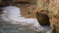 Sand stone cliffs with small hidden beach close up at Algarve coastline Portugal 4k or 4k+ Resolution