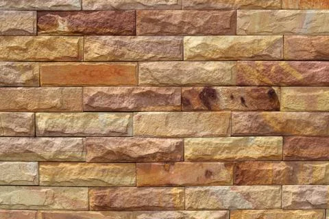 Sand stone wall surface, background of decorate - wallpaper Stock Photos
