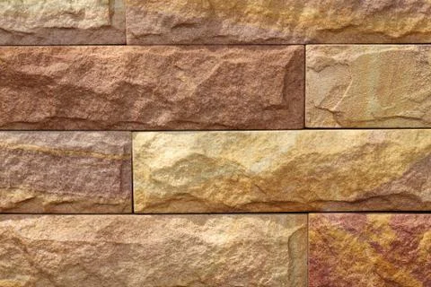Sand stone wall surface, background of decorate - wallpaper Stock Photos