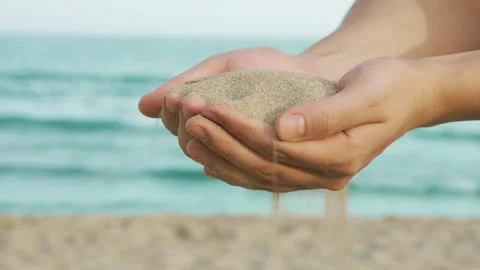 Sand Strewed from Hands between Fingers Stock Footage 131573893