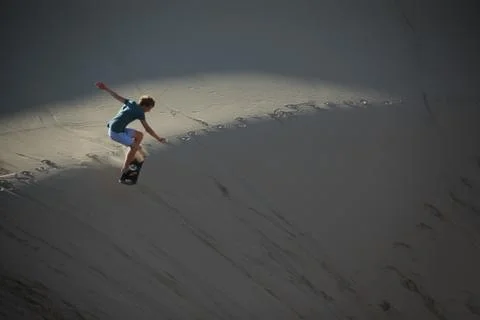 Sand surfing at dusk Stock Photos