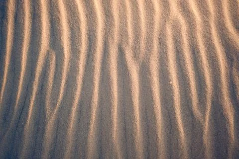 Sand texture at the beach in the evening Stock Photos