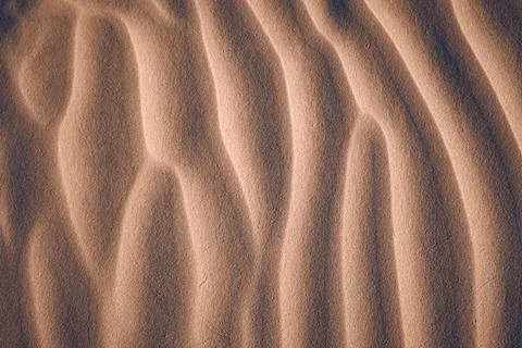 Sand texture formed by wind at the beach Stock Photos
