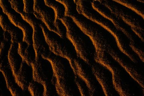 Sand texture outlined by the wind. Wavy shapes of light and shadow. 写真素材