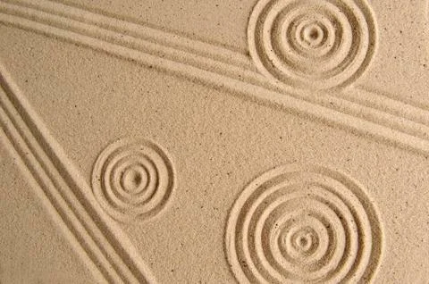 Sand texture, patterns drawn in sand Stock Photos