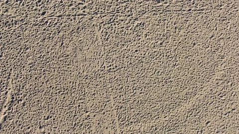 Sand textures. Top down shot. Aerial view of orange sand. Beach sand details. Na Stock Footage 137863952