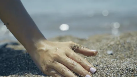 Sand as the time slips through your fingers. girl holding a sand sea background. Stock Footage 133773526