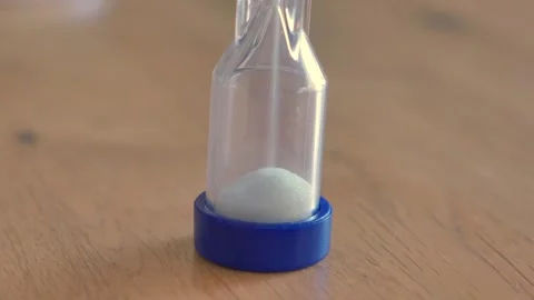 Sand timer and hour glass sitting on a table Stock Footage 337876267