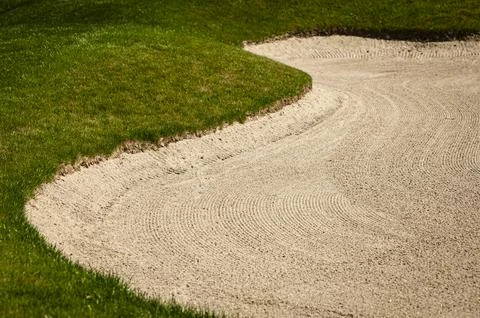 A sand trap on a golf course Stock-Fotos