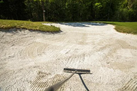 Sand trap, rake in a golf course sand bunkers, raking the sand Stock Photos