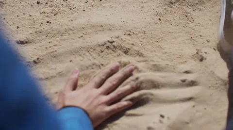Sand trickling through man's hand.Close up view. Couple 스톡 동영상 56058170