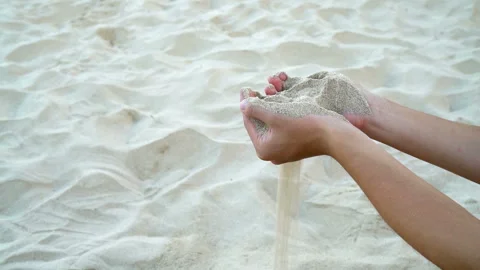 Sand in two hand with sandy floor background ,slow motion movement Stock Footage 235416301