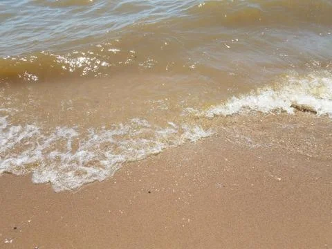 Sand with waves and rocks Stock Photos