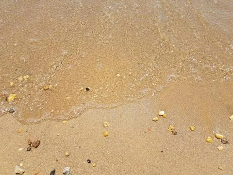 Sand with waves and rocks Stock Photos