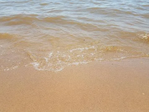 Sand with waves and rocks Stock Photos