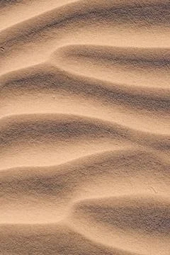 Sand waves formed by wind at the beach Stock Photos