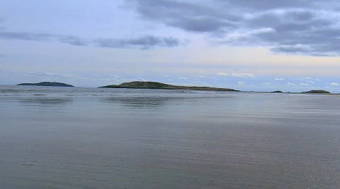 Sand, waves, island with dramatic sky Stock Footage 539039