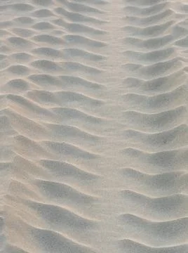 Sand waves pattern created by the wind on the beach Stock Photos