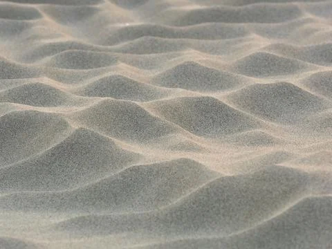 Sand waves pattern created by the wind on the beach Stock Photos