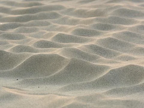 Sand waves pattern created by the wind on the beach Stock Photos
