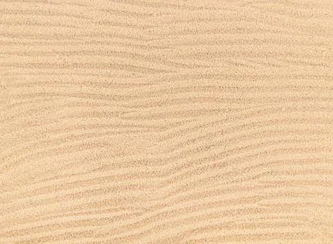 Sand waves texture background, beach top view. Stock Photos