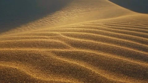 Sand waving in the wind in dunes in desert. Grains of sand move along the sand Stock Footage