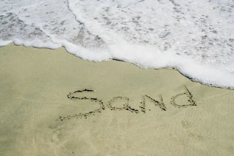 Sand written on beach Stock Photos