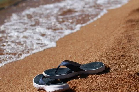 Sandals on beach Stock Photos
