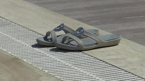 Sandals Next To A Swimming Pool Stock Footage 95784502