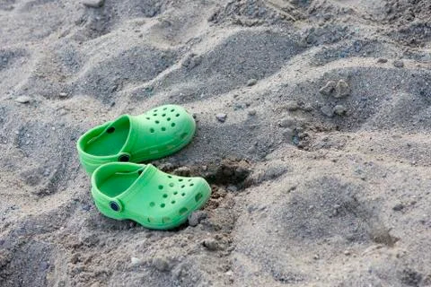 Sandals on the sandy beach Stock Photos