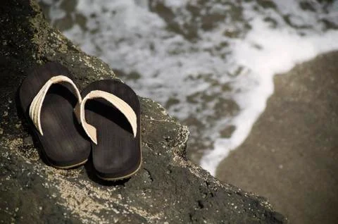 Sandals by the shore Stock Photos
