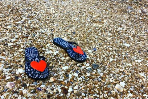 Sandals on the stone beach Stock Photos