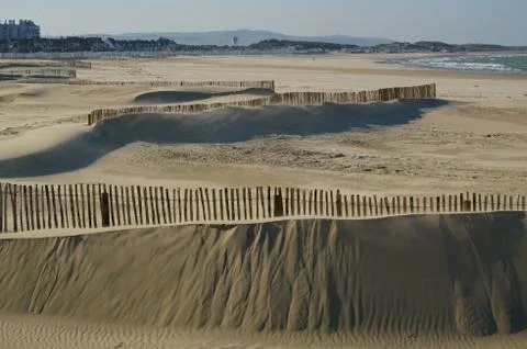 Sandbarriers on a beach Stock Photos