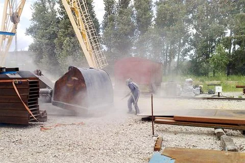 Sandblasting process. Cleaning the metal construction surface from rust before Stock Photos