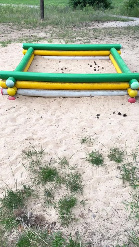 Sandbox made of bars on the playground. Summer. Vertical video Stock Footage 282445477