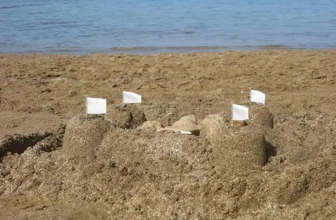 Sandcastles with flags Stock Photos