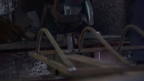 Sander cuts rubber hose in dark workshop Stock Footage 102173981