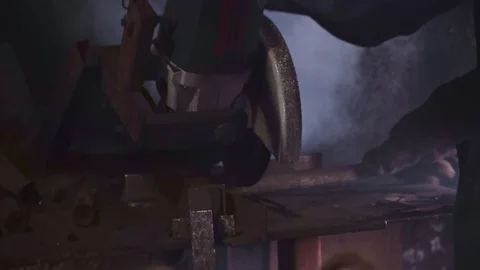 Sander cuts rubber hose in dark workshop closeup Stock Footage 102174004