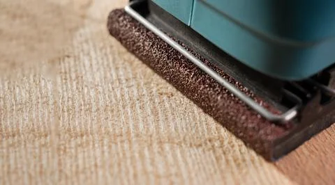 Sander machine on wooden board. Macro DOF. Stock Photos