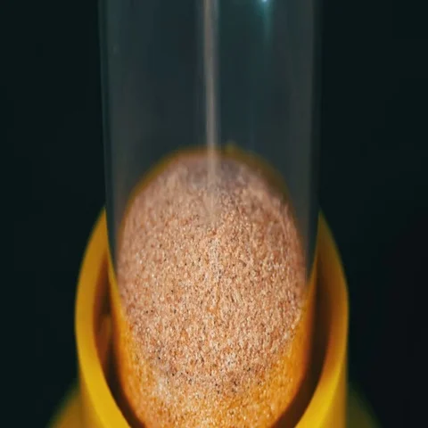 Sandglass on a Black Background, the Sand Falls Inside Stock Footage