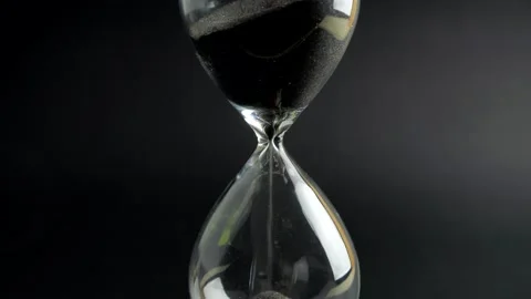 Sandglass clock closeup on black background. Time concept Stock Footage 137644479