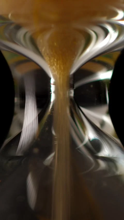 Sandglass isolated on black background. Time is running. Hourglass closeup Stock Footage 327208476