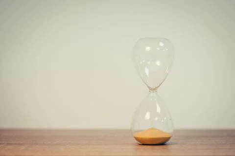 Sandglass, sand timer, concept of passing time, deadline, toned image 스톡 사진