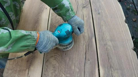 Sanding solid boards with an emery machine, top view Stock Photos