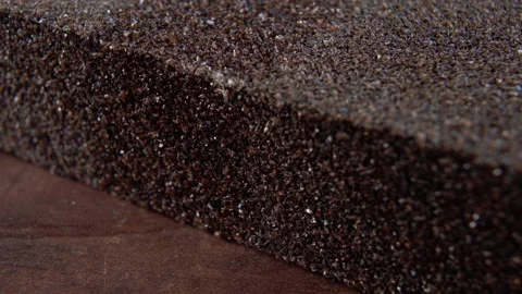 Sanding sponge block on wooden surface. Abrasive sandpaper rough texture. Mac Stock Footage 170307739